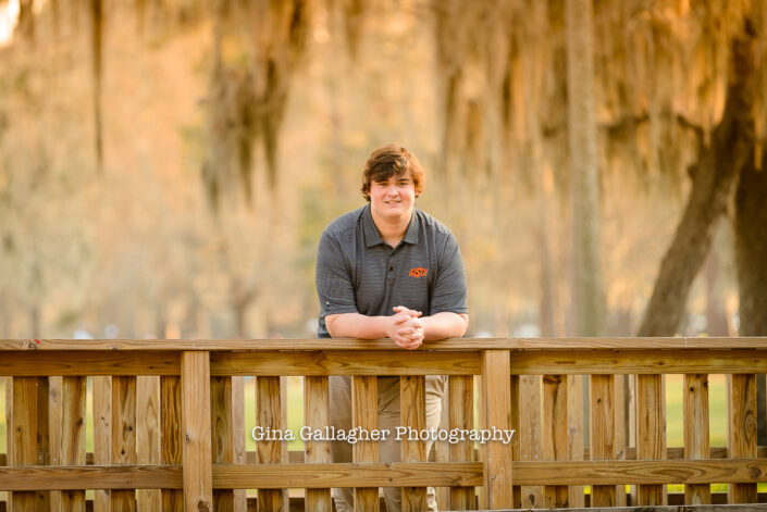 Senior Guy leaning on a bridge railing